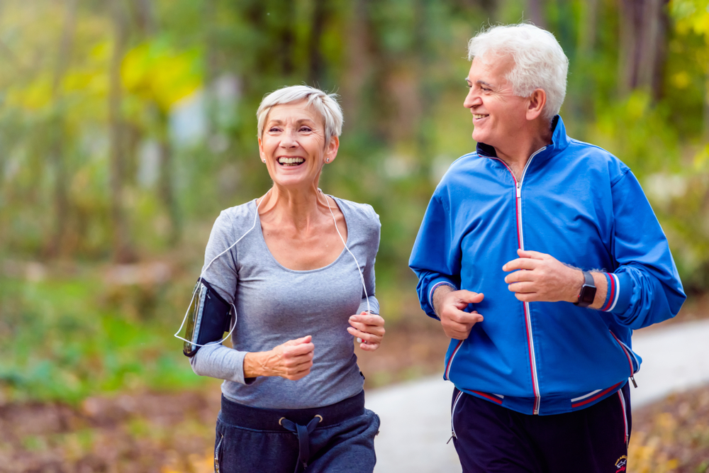Older couple jogging outside